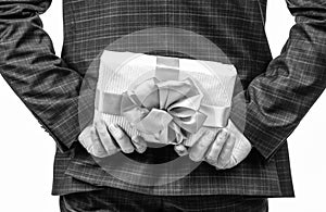 preparing a surprise. businessman holding gift box. corporate present. womens day.