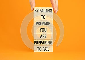 Preparing symbol. Concept words By failing to prepare you are preparing to fail on wooden blocks on a beautiful orange background