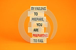 Preparing symbol. Concept words By failing to prepare you are preparing to fail on wooden blocks on a beautiful orange table