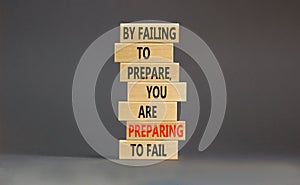 Preparing symbol. Concept words By failing to prepare you are preparing to fail on wooden blocks on a beautiful grey table grey