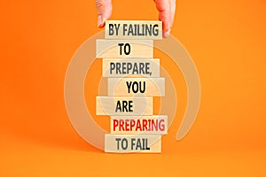 Preparing symbol. Concept words By failing to prepare you are preparing to fail on wooden blocks on a beautiful orange background