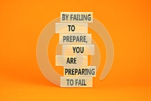 Preparing symbol. Concept words By failing to prepare you are preparing to fail on wooden blocks on a beautiful orange table