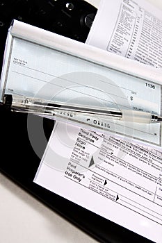 Preparing Taxes - Check and Forms on Keyboard