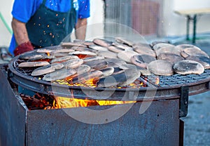 Preparing to cook Panigacci, a speciality flat bread from Lunigiana, north Tuscany, Italy. Here, heating the testi - photo