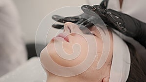 preparing to microneedle procedure, a facial rejuvenation procedure for a woman. close up