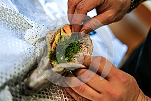 Preparing trouts with lemons, butter and fresh dill.