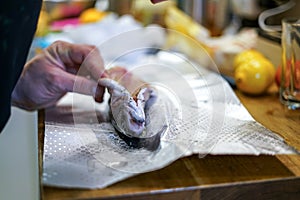 Preparing trouts with lemons, butter and fresh dill.