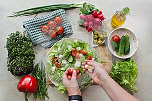 Preparing a vegetable salad with tomato and mozzarella