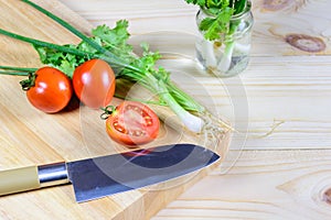 Preparing vegetables for cooking on chopping wood board