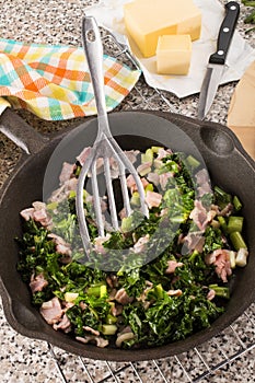 Preparing a very irish dish colcannon with kale and bacon