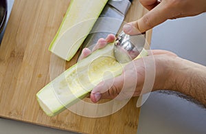 Preparing zuchini hands on the kitchen table close up