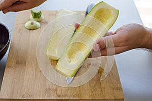 Preparing zuchini hands on the kitchen table close up