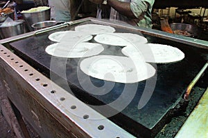 Prepartion of Masala Dosa - a pancake from South India.