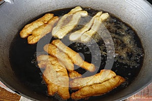 Prepation of Fried bread stick, Cakwe , the bread is also popularly known as Youtiao and Cakoi, a popular Chinese cuisine. The