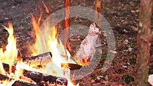 A prepper cooks food on an open fire.