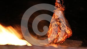 A prepper cooks food on an open fire.