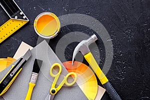 Preraring for home repair. Tools on balck stone desk background top view