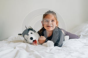 Preschool age child girl with favourite toy dog.