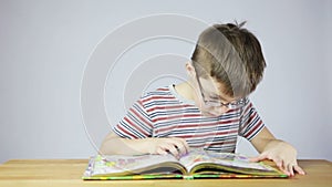 Preschool boy reading a book