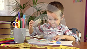 A preschool boy takes counting sticks out of a box for a math lesson. He prepares for lessons.