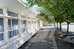 Preschool building schoolyard exterior with playground and tree