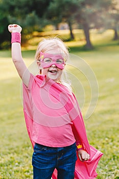Preschool Caucasian child playing superhero in costume