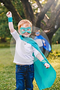 Preschool Caucasian child playing superhero in costume