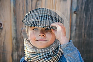 Preschool child. Boy face. Elegant child. Autumn weather. People, adorable kid, funny portrait. Cap, hat and scarf.