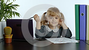 Preschool child girl distance online learning at home. Kid studying using digital laptop computer