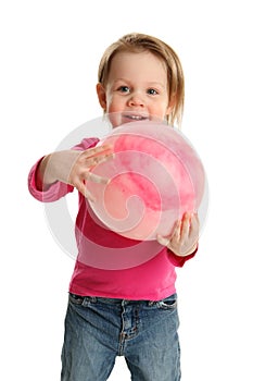 Preschool child playing with a ball