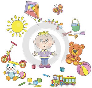 Preschool child surrounded by his funny toys