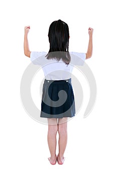 Preschool child in uniform with her hands up at studio. Isolated