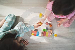 Preschool games. Children play with wooden cubes. The child passes the red cube. Kids build houses.