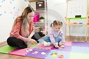 Preschool girl doing a puzzle at a child`s therapist office photo