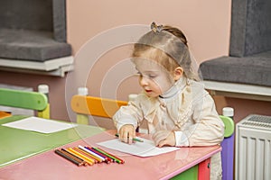 Preschool Girl Focused on Coloring Activity