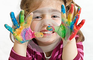 Preschool girl with painted hands