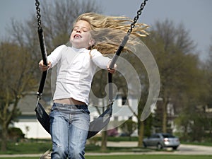 Preschool girl on swing