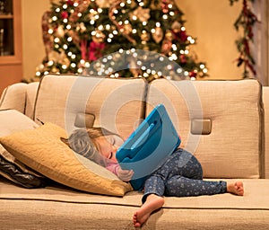 Preschool girl using a tablet computer at home at Christmas