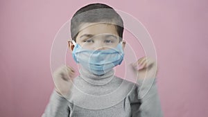 Preschool kid boy wearing a medical face mask