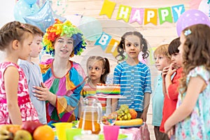 Kids celebrating birthday party with clown