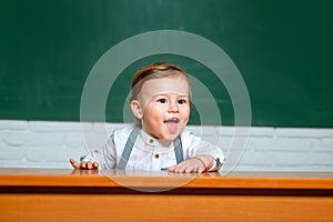 Preschool kids. Learning and education concept. Back to school. Funny preschooler on blackboard background.