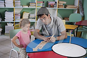 Preschool teacher and child in the classroom