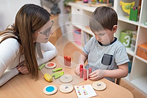 Preschool Teacher with Kid Having Creative Educational Activities photo