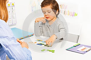 Preschooler boy and developing game with card