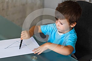 Preschooler boy learn writing letters