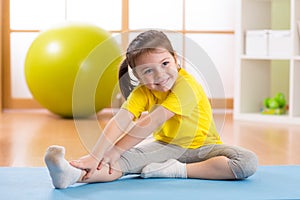 Preschooler child girl doing fitness exercises