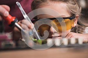 Preschooler child learning to braze with her