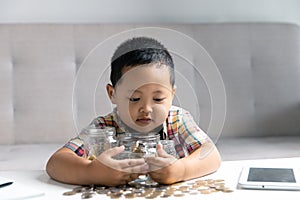 Preschooler child learning to calculate personal budget, manage finance, playing investment, accounting. Focused school kid saving
