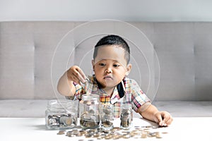 Preschooler child learning to calculate personal budget, manage finance, playing investment, accounting. Focused school kid saving