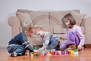 Preschooler children playing with toy blocks